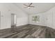 Bright living room with high ceilings, modern ceiling fan, wood flooring, and natural light from the front window at 3651 N Goldenrod Rd # 204, Winter Park, FL 32792