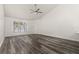 Bright living room featuring high ceilings, wood flooring, and a modern ceiling fan at 3651 N Goldenrod Rd # 204, Winter Park, FL 32792