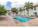 View of the community pool with a brick patio and palm trees at 3651 N Goldenrod Rd # 204, Winter Park, FL 32792