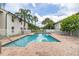 Community pool area showcasing the sparkling pool, brick paver deck, and surrounding palm trees at 3651 N Goldenrod Rd # 204, Winter Park, FL 32792