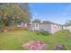 Large backyard with a grassy area and wooden fence at 6937 Gibraltar Rd, Orlando, FL 32822