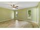 Spacious bedroom with wood-look tile floors and two windows at 685 Chelsea Rd, Longwood, FL 32750