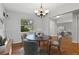 Staged dining room with table set, chairs, chandelier, and view to living room at 685 Chelsea Rd, Longwood, FL 32750