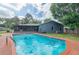 Backyard view of a private swimming pool with brick trim, screened patio, and blue exterior at 685 Chelsea Rd, Longwood, FL 32750