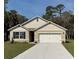 Charming single-story home featuring a well-manicured lawn, a two-car garage and craftsman-style accents at 1552 Lakeside Dr, Deland, FL 32720