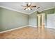 Bedroom with neutral green walls, ceramic tile floors, and doorway to hall at 1730 Stafford Springs Blvd, Mount Dora, FL 32757