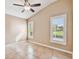 Bedroom with tile flooring, vaulted ceiling and two windows with plantation shutters at 1730 Stafford Springs Blvd, Mount Dora, FL 32757