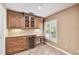 Butler's Pantry with storage cabinets, wine cooler and lots of counter space next to a window at 1730 Stafford Springs Blvd, Mount Dora, FL 32757