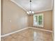 Dining room with tile flooring, chandelier and a window with plantation shutters at 1730 Stafford Springs Blvd, Mount Dora, FL 32757