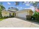Inviting home exterior featuring a two-car garage, beautiful landscaping, and a charming facade at 1730 Stafford Springs Blvd, Mount Dora, FL 32757