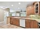 Kitchen with wood cabinets, stainless steel dishwasher, white sink and tile countertops at 1730 Stafford Springs Blvd, Mount Dora, FL 32757