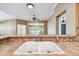 Kitchen sink featuring tile countertops, stainless steel fixtures, and a view to the enclosed patio area at 1730 Stafford Springs Blvd, Mount Dora, FL 32757