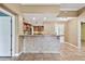 Bright kitchen featuring a tiled breakfast bar, tile floors, warm-toned walls, and stainless steel appliances at 1730 Stafford Springs Blvd, Mount Dora, FL 32757