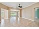Open concept living room with tile flooring and access to the screened in porch at 1730 Stafford Springs Blvd, Mount Dora, FL 32757