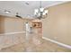 Open concept living room with tile flooring, chandelier and view into kitchen at 1730 Stafford Springs Blvd, Mount Dora, FL 32757