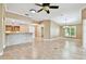 Open concept living room with tile flooring, chandelier, and view into kitchen at 1730 Stafford Springs Blvd, Mount Dora, FL 32757