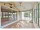 Inviting sunroom with tile flooring, adorned with string lights, blending indoor and outdoor living at 1730 Stafford Springs Blvd, Mount Dora, FL 32757