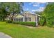 Enclosed sunroom with screened windows and manicured lawn at 1730 Stafford Springs Blvd, Mount Dora, FL 32757