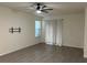 Bright living room with tile floors, ceiling fan, and sliding glass doors at 16613 Point Rock Dr, Winter Garden, FL 34787