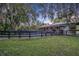 Exterior view of barn with horses in stalls at 2075 Genova Dr, Oviedo, FL 32765