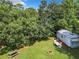 Aerial view of backyard, showing shed and large trees at 290 Valencia Rd, Debary, FL 32713