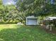 Backyard with shed featuring roll-up garage door at 290 Valencia Rd, Debary, FL 32713