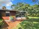 Backyard patio area with small table and chairs at 290 Valencia Rd, Debary, FL 32713