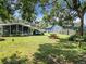 Large backyard with grassy area, picnic table, and trees at 290 Valencia Rd, Debary, FL 32713