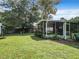 Backyard with screened porch and lush landscaping at 290 Valencia Rd, Debary, FL 32713