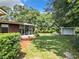 Backyard view of home with screened porch and shed at 290 Valencia Rd, Debary, FL 32713