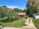 Ranch home with stone exterior and tree-lined driveway at 290 Valencia Rd, Debary, FL 32713