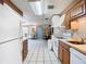 Open kitchen with wood cabinets and a view into the living room at 290 Valencia Rd, Debary, FL 32713