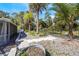 Well-maintained, landscaped backyard with mature trees, stone pavers, and wrought iron fence at 349 La Creek Ct, Debary, FL 32713