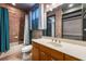 Bathroom featuring a vanity, toilet, bathtub with tile surround, and blue curtains at 349 La Creek Ct, Debary, FL 32713