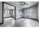 Bright bedroom featuring gray walls, a ceiling fan, tile flooring, floating shelves, and light blue curtains at 349 La Creek Ct, Debary, FL 32713