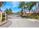 Welcoming gated community entrance with mature palm trees and lush landscaping. A secure and peaceful neighborhood at 349 La Creek Ct, Debary, FL 32713