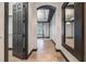 Hallway with an archway, leading to a room with a stylish chandelier and dark trim at 349 La Creek Ct, Debary, FL 32713