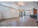 Open-concept living room featuring tile floors, neutral walls, modern lighting, and an entrance to the kitchen at 349 La Creek Ct, Debary, FL 32713