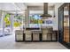 Covered outdoor kitchen with stainless steel appliances, granite countertops, and modern vent hood at 349 La Creek Ct, Debary, FL 32713