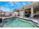 Screened-in pool and patio area with outdoor kitchen, ceiling fans, and privacy landscaping at 349 La Creek Ct, Debary, FL 32713