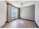 Cozy room featuring a large window with natural light, tile floors, neutral paint and elegant chandelier at 349 La Creek Ct, Debary, FL 32713