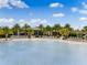 Beautiful community pool with sun loungers and palm trees on sunny day with blue skies and fluffy white clouds at 583 Good Life Way, Daytona Beach, FL 32124