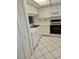 Galley kitchen with white cabinets and appliances at 11 Escondido Cir # 105, Altamonte Springs, FL 32701