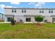 A verdant backyard features a lush lawn, patio access, and charming landscaping at 203 River Front Way, Edgewater, FL 32141