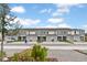 Row of modern townhomes with neutral paint, individual garages, and well-maintained landscaping at 203 River Front Way, Edgewater, FL 32141