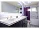 Bathroom featuring dual sinks with a vanity, modern mirror, and bathtub with shower at 337 Goldstone Pl, Lake Mary, FL 32746
