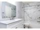 Bathroom featuring a modern vanity with sleek fixtures, mirror, bathtub and marble-style wall at 337 Goldstone Pl, Lake Mary, FL 32746