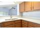 Kitchen area featuring a stainless steel sink, modern countertops, and wooden cabinets at 337 Goldstone Pl, Lake Mary, FL 32746