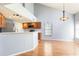 Open concept kitchen and dining area with wooden floors, stainless steel appliances, and lots of light at 337 Goldstone Pl, Lake Mary, FL 32746