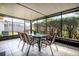 Comfortable sunroom for outdoor dining with tile floors, screen windows, and views of backyard at 337 Goldstone Pl, Lake Mary, FL 32746